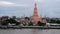 Time lapse of twilight view of Wat Arun across Chao Phraya River during sunset in Bangkok