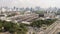 Time-lapse of under construction site, cranes, car traffic transportation on road intersection in downtown district in Asia