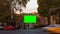 Time lapse video. Advertising billboard with green screen in the center of the autumn cityscape with blurred walking