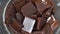 Time lapse video of melting chocolate bar pieces in a bowl view from above