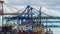 Time lapse. View of activity at a busy cargo container port with the arrival of a commercial cargo ship