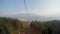 Time lapse of view through ropeway cabin window, recreation in mountains, forest