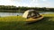 Time Lapse view of the tent and yellow kayak on the shore river. Small clouds on the horizon.