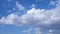 Time-lapse white fluffy clouds changing their shape against a blue sky during the day. Weather change