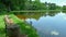 Time-lapse of a wooden bench next to a fishing lake