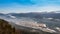 Time-lapsed city between mountains and cloudy sky and fog