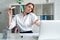 Time for lunch. serious woman eating sandwich, and talking on the phone. Indoor, studio shot. Business people concept,