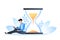 Time management concept, organization of working time, deadline. A young man sits with a laptop near the hourglass. Vector