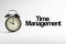 TIME MANAGEMENT inscription written and alarm clock on white background