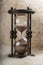 Time is money. Antique hourglass.