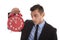 Time is money : businessman holding up red alarm clock isolated