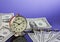 Time is money, vintage clock on cash american dollar bills and coins with nice blue background. Business Commerce concept