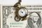 Time is money. watch on a chain and a banknote on a white background.