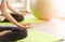 Time for practicing yoga. Two youngs attractive women sitting in Ardha Padmasana exercise, Lotus pose on meditation