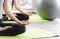 Time for practicing yoga. Two youngs attractive women sitting in Ardha Padmasana exercise, Lotus pose on meditation, closed eyes