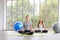 Time for practicing yoga. Two youngs attractive women sitting in Ardha Padmasana exercise, Lotus pose on meditation, closed eyes,