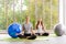 Time for practicing yoga. Two youngs attractive women sitting in Ardha Padmasana exercise, Lotus pose on meditation, closed eyes