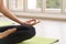 Time for practicing yoga. Youngs attractive woman sitting in Ardha Padmasana exercise, Lotus pose on meditation, closed eyes