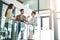 Time for a quick catch up in the office. Shot of a group of colleagues talking together in a large modern office.