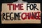 `Time for regime change` protest placard close up