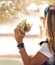 Time for some tasty. a young woman eating a hamburger outside.