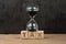 Time for tax, countdown for tax day or taxation timer concept, sandglass or hourglass on wood block with alphabets combine word
