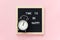 Time to be happy. Motivational quote on letterboard and black alarm clock on pink background. Top view Flat lay Concept