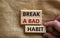 Time to break a bad habit. Wooden blocks with words `break a bad habit`. Beautiful canvas background, male hand. Copy space.