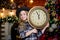 Time to celebrate. Happy new year. cowgirl child with big clock. Xmas tree. Happy holiday. Little girl in cowboy hat