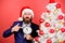 Time to celebrate. Man bearded wear suit and santa hat hold clock. Businessman join christmas celebration. Last minute