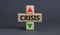 Time to crisis symbol. A wooden cubes with up icon. Wooden cubes with the concept word Crisis. Beautiful grey table grey