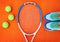 Time to hit the court. High angle shot of tennis essentials placed on top of an orange background inside of a studio.