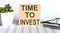 TIME TO INVEST - words from wooden blocks with letters, the time is now concept