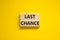 Time to last chance symbol. Concept words Last chance on wooden blocks on a beautiful yellow background. Business and time to last