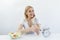 Time to lose weight , eating control or time to diet concept. Retro alarm clock in which woman make Intermittent fasting with a