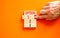 Time to option 1 symbol. Concept word Option 1 2 3 on wooden block. Businessman hand. Beautiful orange table orange background.