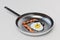time to prepare breakfast. alarm clock with scrambled eggs and sausages in a frying pan. 3D render
