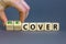 Time to recover symbol. Businessman turns wooden cubes and changes the word `cover` to `recover`. Beautiful grey background.