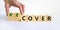 Time to recover symbol. Businessman turns wooden cubes and changes the word `cover` to `recover`. Beautiful white background.