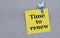 TIME TO RENEW - words on yellow paper with clothespin on gray background