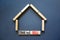 Time to sell house symbol. Concept words `Time to sell` on wooden blocks near miniature house. Beautiful grey background, copy