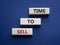 Time to Sell symbol. Concept words Time to Sell on wooden blocks. Beautiful deep blue background. Business and Time to Sell