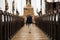 Time to talk to the Big Man upstairs. Rearview shot of a senior man walking down the aisle of a church.