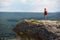 Time to travel. Summer holidays and vacation time. Breathtaking mountains view. Lovely woman standing at edge of cliff