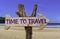 Time to Travel wooden sign with a beach on background