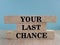 Time to your last chance symbol. Concept words Your last chance on brick blocks on a beautiful wooden table blue background.