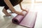 Time for yoga. girl unfolds yoga mat at home, sportswoman is ready to do yoga, close-up