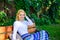 Time for yourself. Woman blonde take break relaxing in park. Girl sit bench relaxing in shadow, green nature background