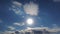 Timelapse 4k, the Sun shines above the clouds in the blue sky. Amazing cloudscape, the sun rays beautifully piercing the