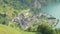 Timelapse, Aerial view on cars and trains traffic through small Swiss town surrounded by lake and mountains. Lake Lucerne, Sisikon